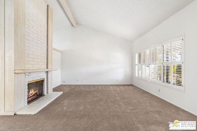 unfurnished living room with vaulted ceiling with beams, a brick fireplace, and carpet flooring