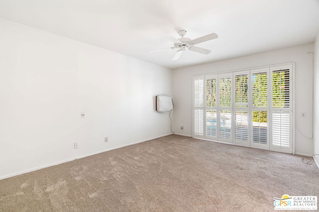 unfurnished room featuring light carpet and ceiling fan