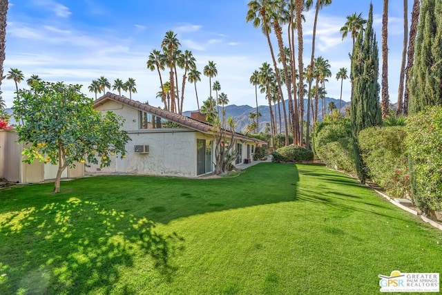 view of yard with a mountain view and a wall mounted air conditioner