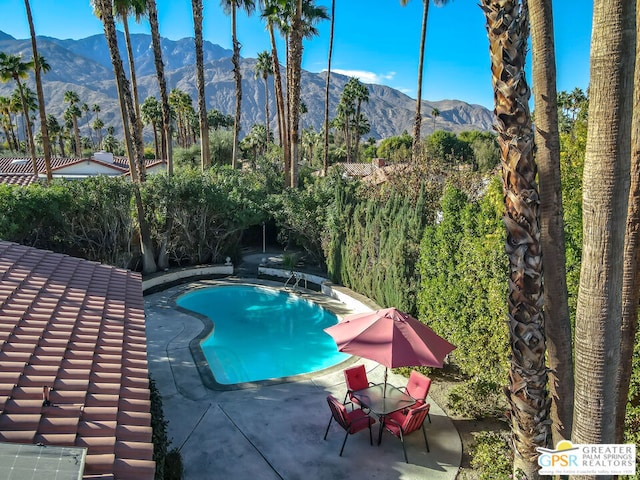 view of pool featuring a patio area and a mountain view