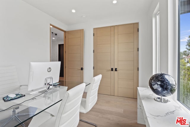 office with light wood-type flooring