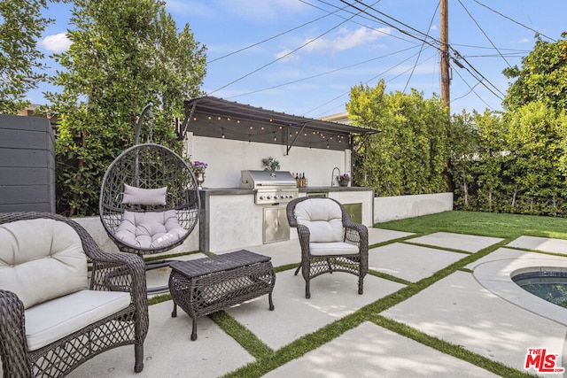 view of patio / terrace featuring exterior kitchen, sink, and grilling area