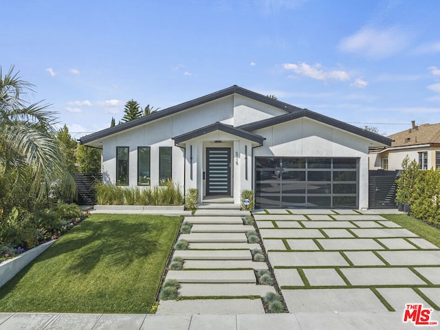 view of front of house with a front yard and a garage