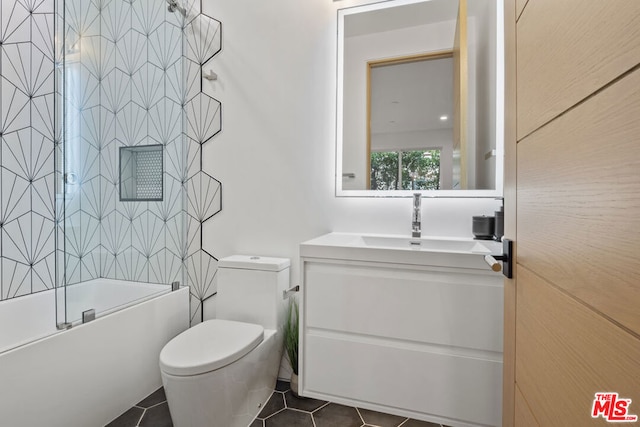 full bathroom featuring toilet, enclosed tub / shower combo, tile patterned flooring, and vanity