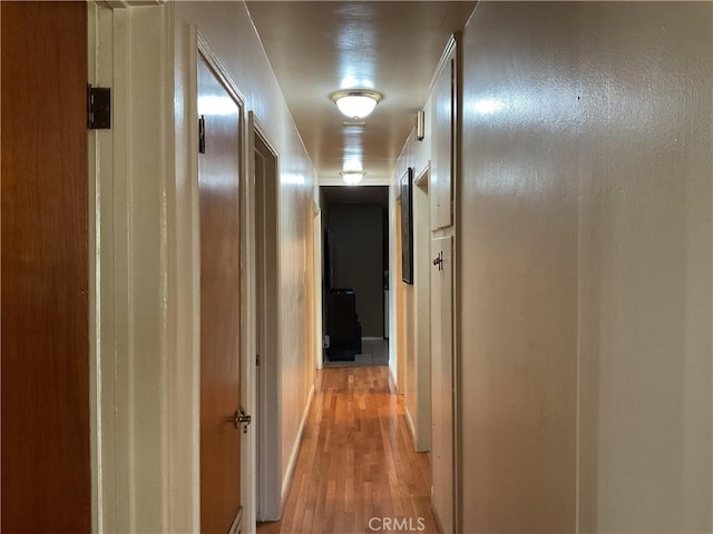 corridor with light wood-type flooring