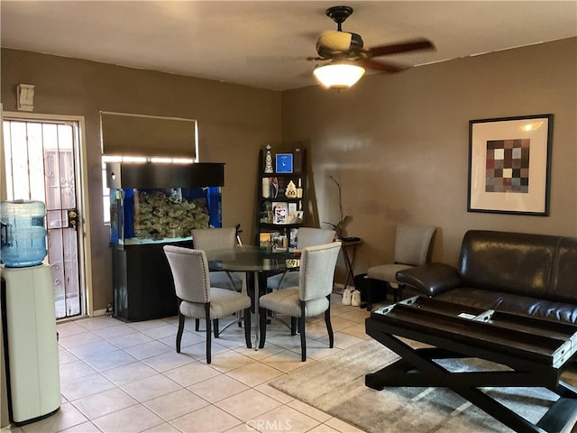 dining space featuring ceiling fan and light tile patterned flooring