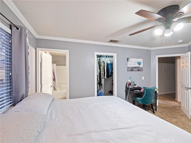 bedroom with ceiling fan, ensuite bathroom, a closet, and ornamental molding