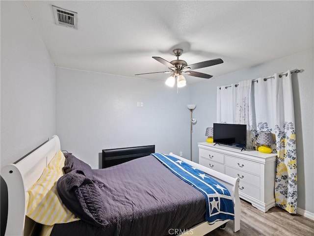 bedroom with ceiling fan and light hardwood / wood-style floors