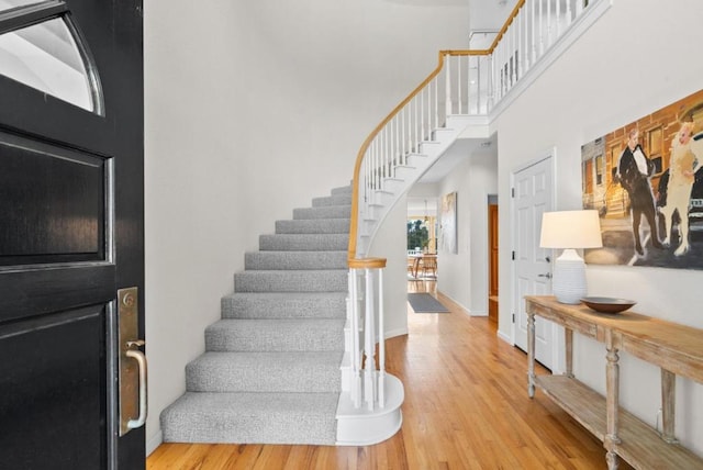 foyer with hardwood / wood-style flooring and a high ceiling