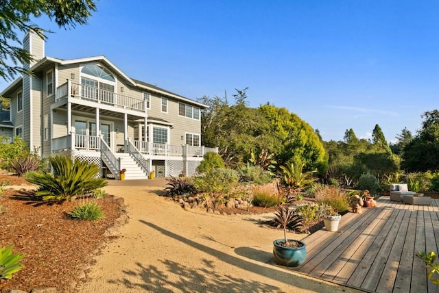 back of property with a balcony