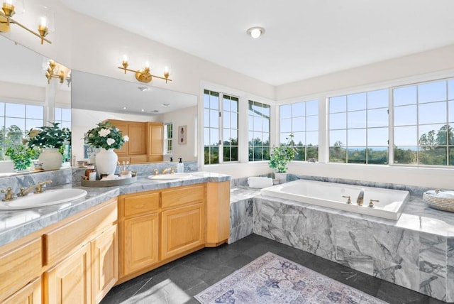 bathroom with vanity, plenty of natural light, and tiled bath