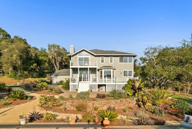 back of property with a balcony