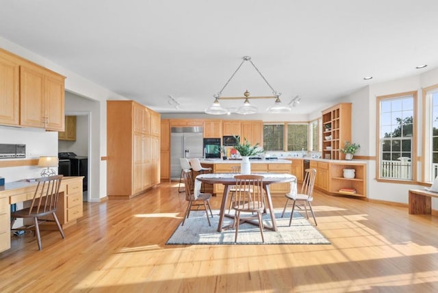 dining room with rail lighting and light wood-type flooring