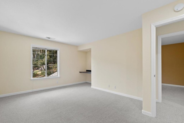 unfurnished room with light colored carpet