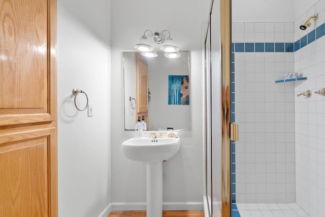 bathroom with a shower with door