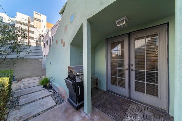 property entrance with a patio area and french doors