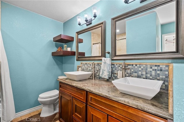 bathroom with toilet, tasteful backsplash, tile patterned floors, vanity, and curtained shower