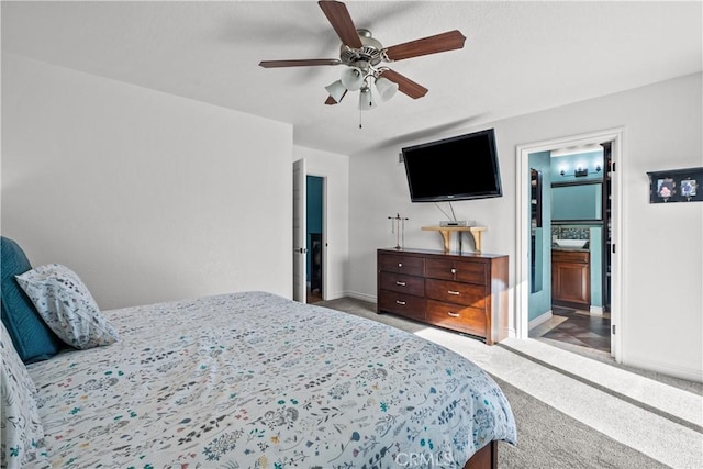 carpeted bedroom featuring ceiling fan and connected bathroom