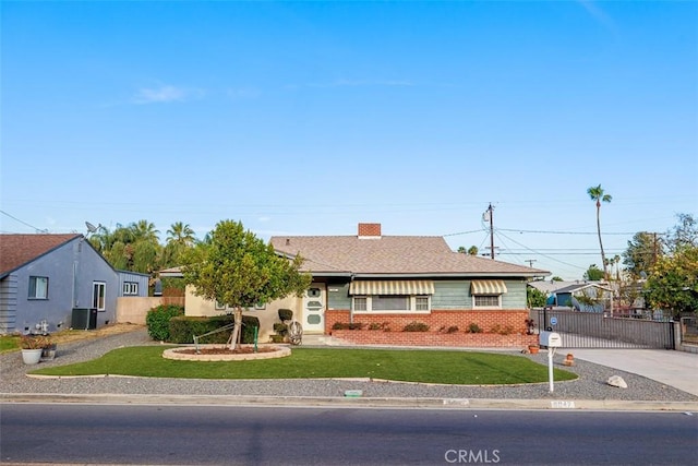 view of front of house with a front lawn and central air condition unit