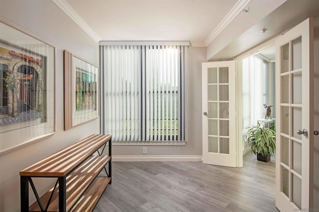 interior space with french doors, crown molding, and hardwood / wood-style floors