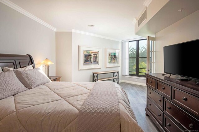 bedroom featuring dark hardwood / wood-style flooring and crown molding