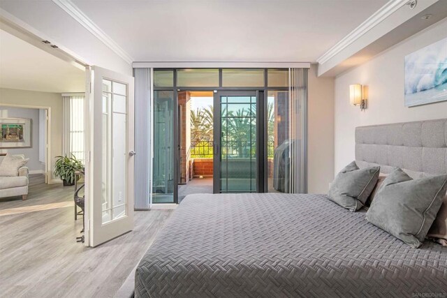 bedroom with floor to ceiling windows, wood-type flooring, crown molding, and access to outside