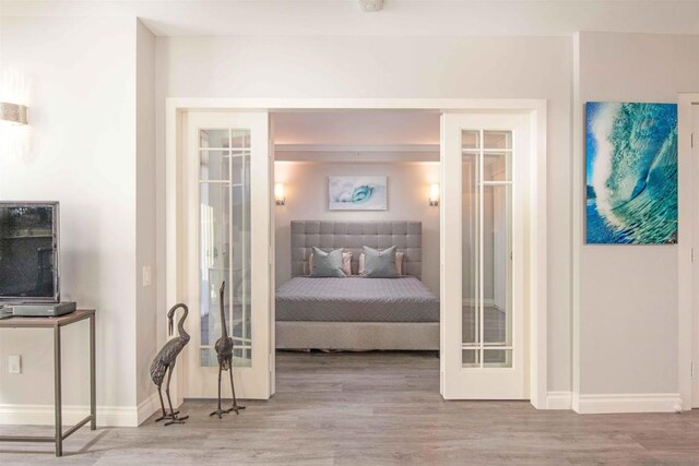 bedroom featuring hardwood / wood-style flooring and french doors