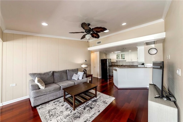 living room featuring ceiling fan, dark wood-type flooring, and ornamental molding