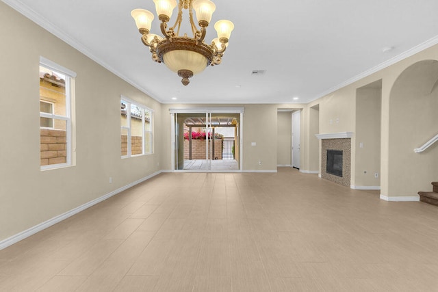 unfurnished living room featuring crown molding and an inviting chandelier