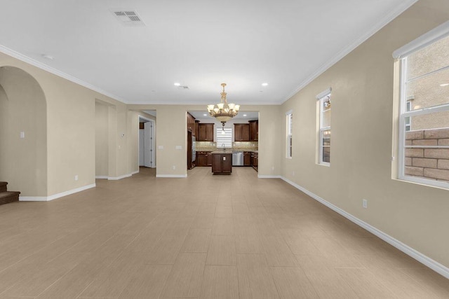 unfurnished living room with a notable chandelier and crown molding