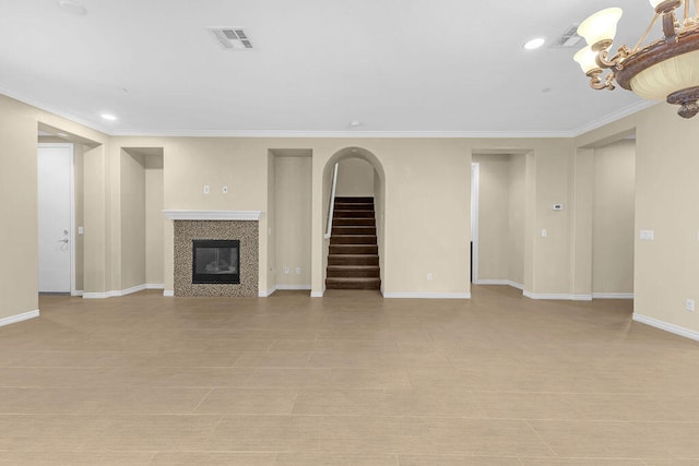 unfurnished living room featuring light tile patterned floors, a tile fireplace, and crown molding