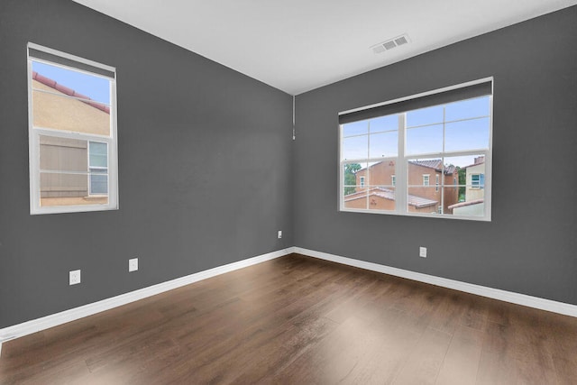 empty room with dark wood-type flooring