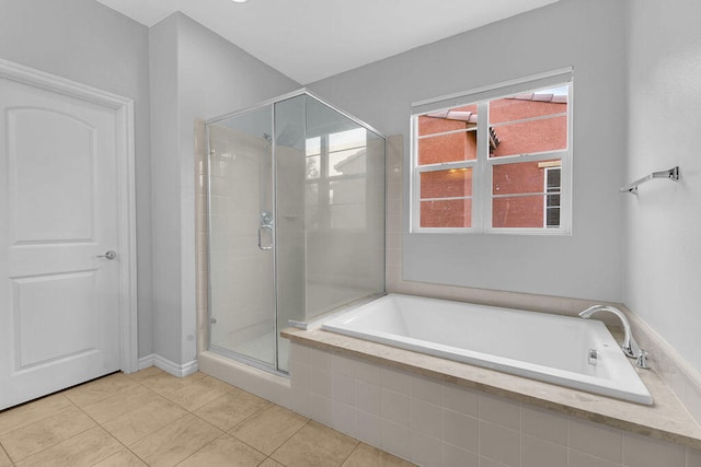 bathroom with separate shower and tub and tile patterned flooring