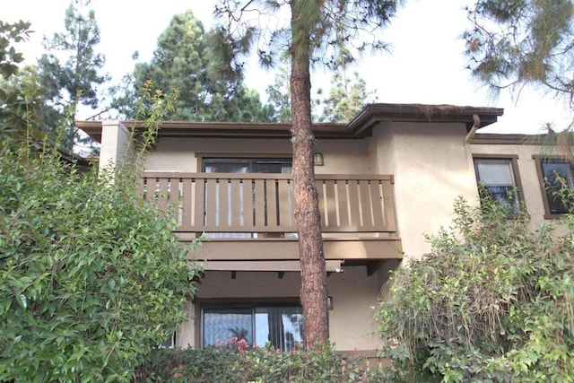 back of house featuring a balcony