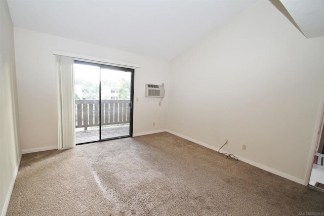 carpeted spare room with vaulted ceiling and an AC wall unit