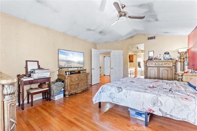 bedroom with lofted ceiling, ceiling fan, and light hardwood / wood-style flooring