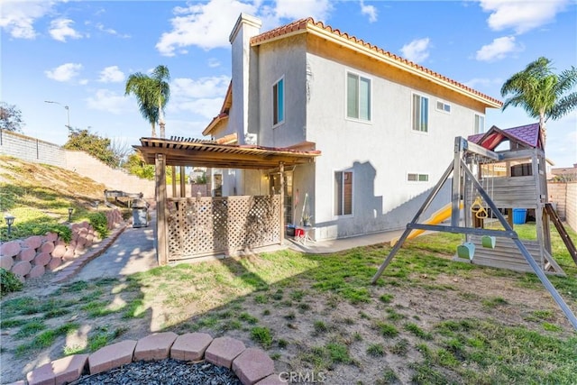 rear view of house with a pergola