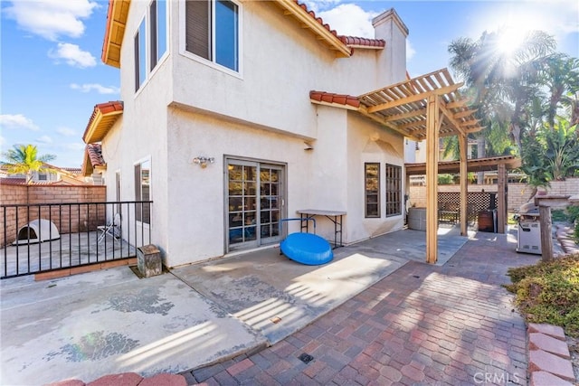 rear view of house with a pergola and a patio area