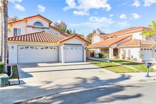 mediterranean / spanish house with a front lawn and a garage