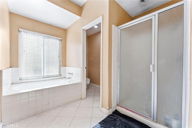 bathroom featuring separate shower and tub, tile patterned floors, and toilet