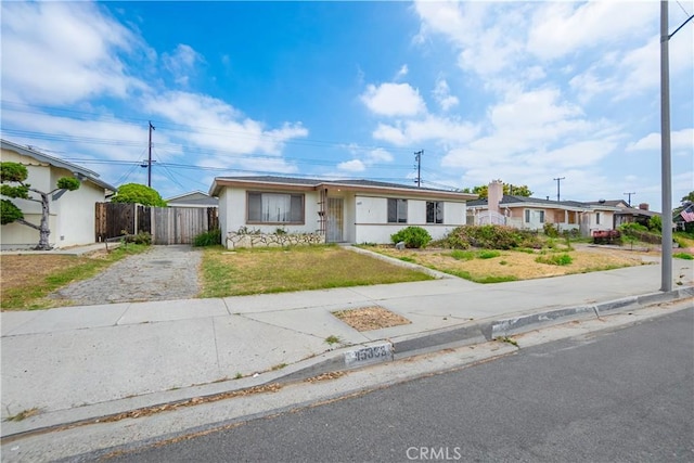 ranch-style home with a front lawn