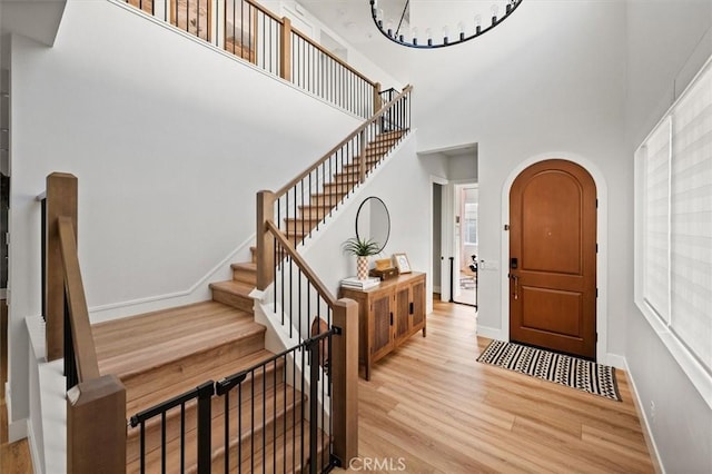 foyer with a high ceiling and light wood-type flooring