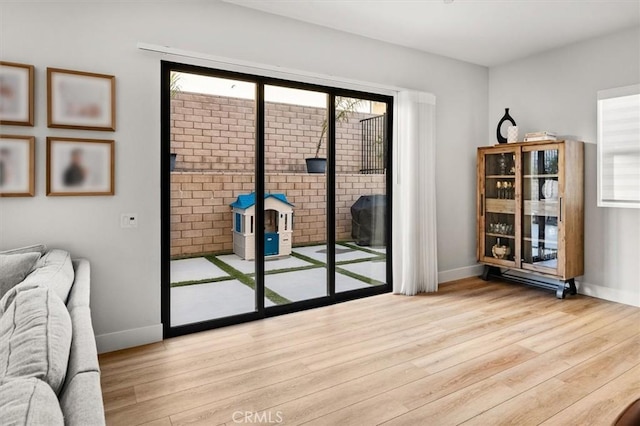 doorway with light wood-type flooring