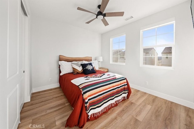 bedroom with ceiling fan and light hardwood / wood-style flooring