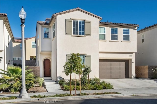 mediterranean / spanish-style home with a garage