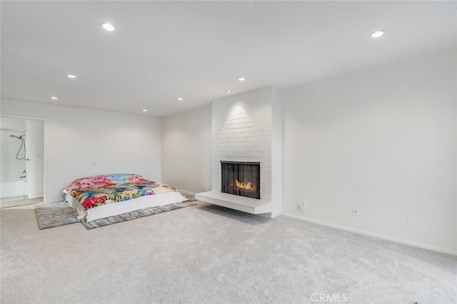 carpeted living room featuring a fireplace