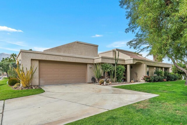 view of front facade with a front lawn and a garage