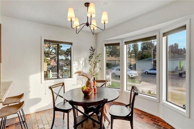 dining area featuring a wealth of natural light and a notable chandelier