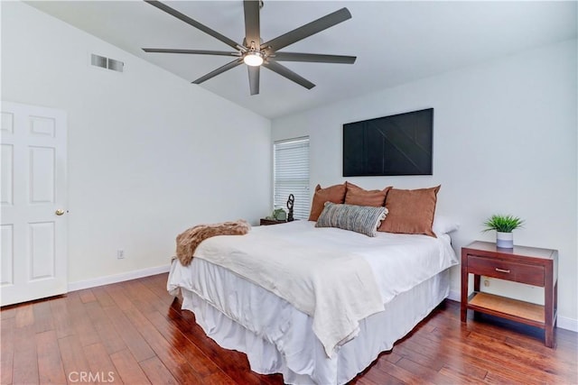 bedroom with vaulted ceiling, ceiling fan, and hardwood / wood-style floors