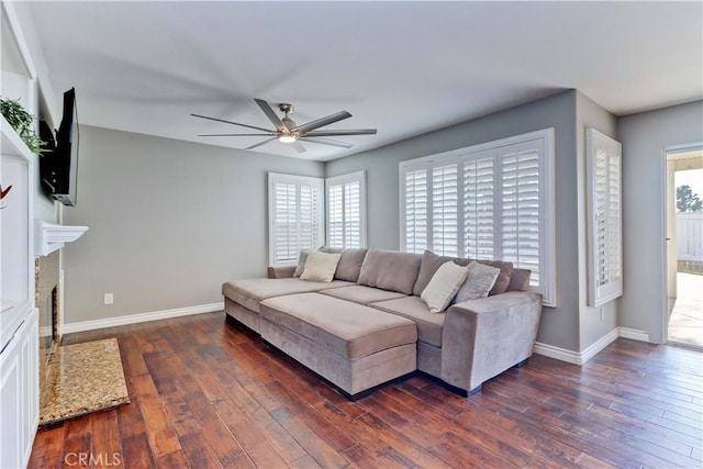 living room featuring ceiling fan and dark hardwood / wood-style floors